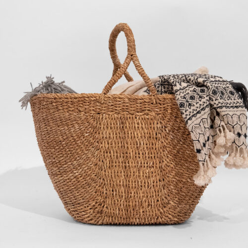 A Hogla basket with soft handles with a scarf on it.