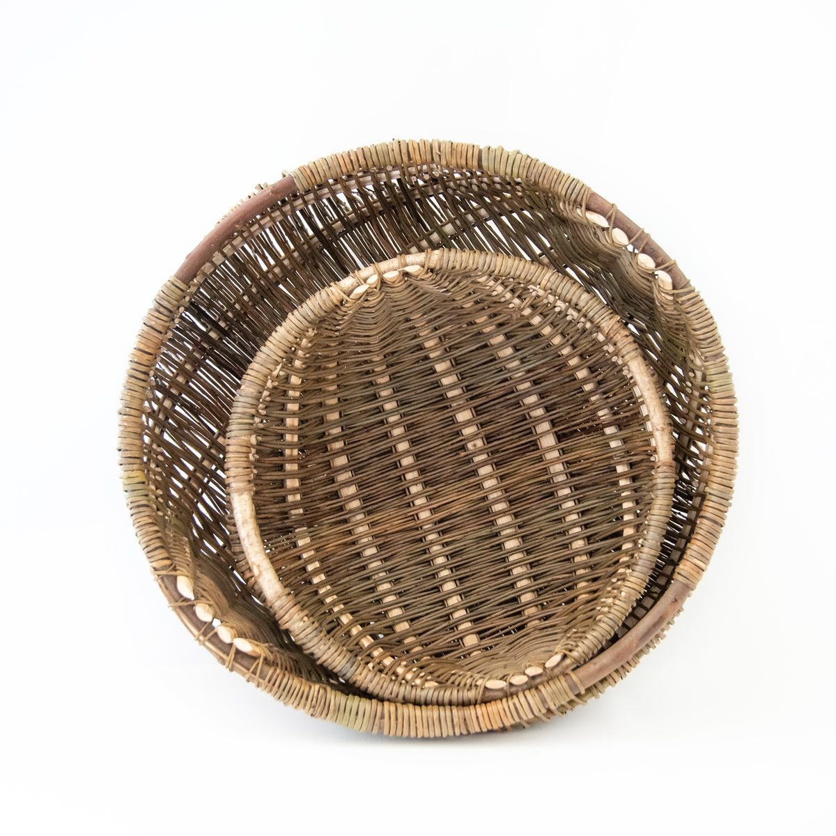 Two wicker baskets on a white background.