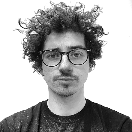 A man with curly hair and glasses.