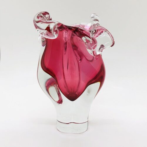 A pink glass vase with a swirl design.