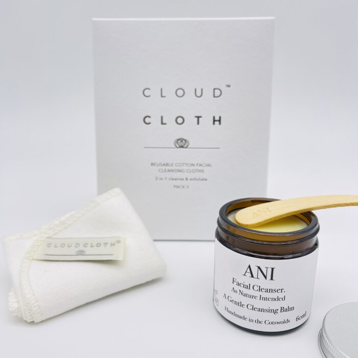 A box with a cloud cloth and a brush next to it.