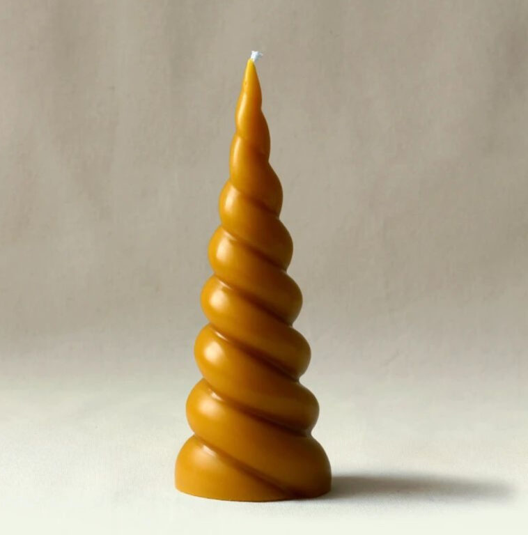 A yellow candle with a spiral shape.