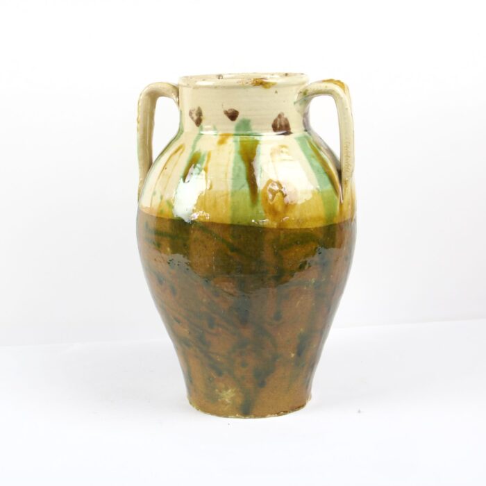 A green and brown vase with handles on a white background.