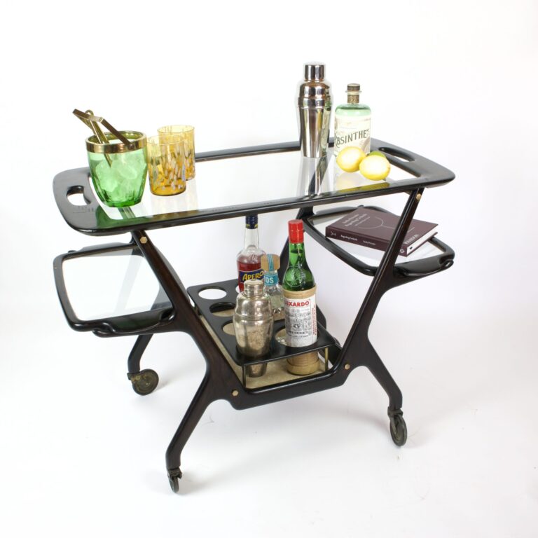 A bar cart with a glass top and bottles on it.