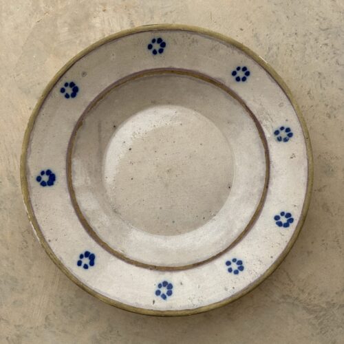 A blue and white plate with flowers on it.